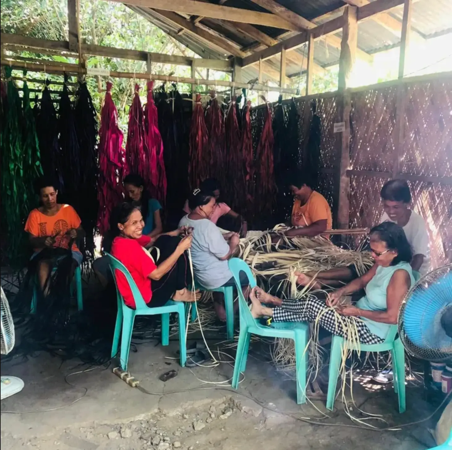 Bolinao weavers hand-weaving buri fibers together